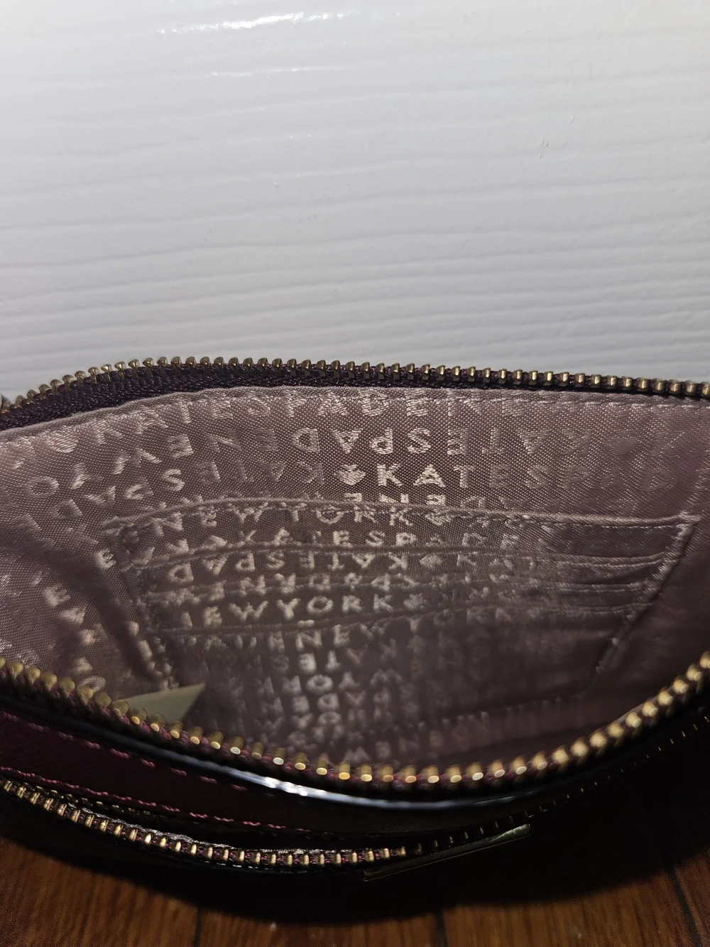 kate spade burgundy wristlet with gold hardware